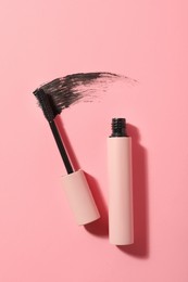 Mascara for eyelashes and smear on pink background, flat lay. Makeup product Photo of Mascara for eyelashes and smear on pink background, flat lay. Makeup product