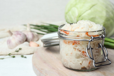 Tasty fermented cabbage on white wooden table, closeup Photo of Tasty fermented cabbage on white wooden table, closeup
