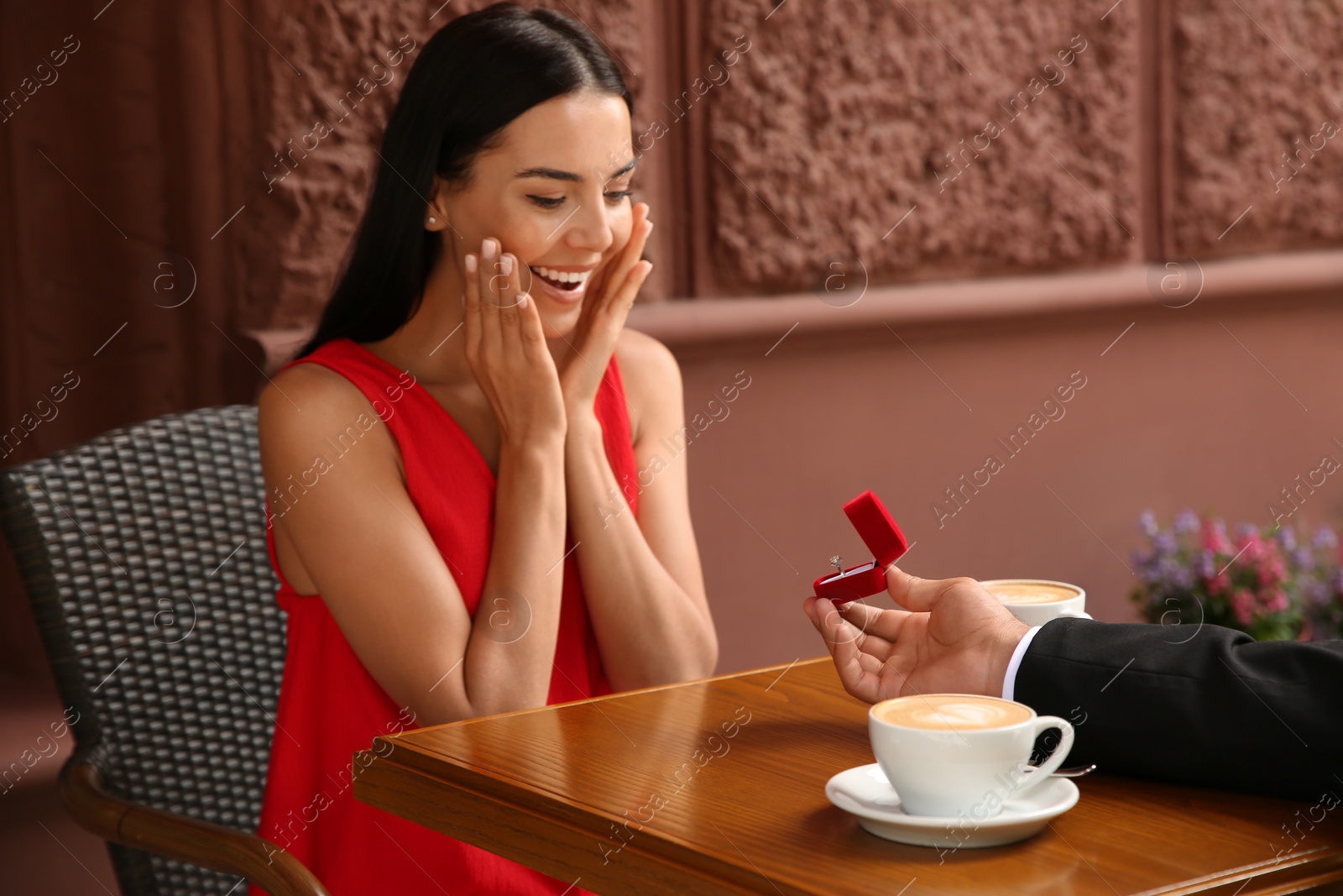 Man with engagement ring making proposal to his girlfriend in outdoor cafe Photo of Man with engagement ring making proposal to his girlfriend in outdoor cafe