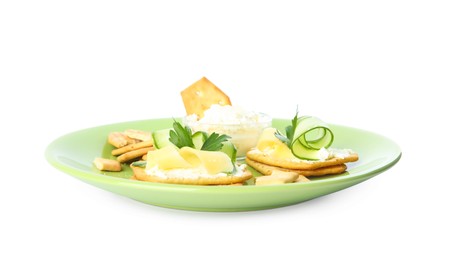 Delicious crackers with cream cheese, cucumber and parsley on white background Photo of Delicious crackers with cream cheese, cucumber and parsley on white background