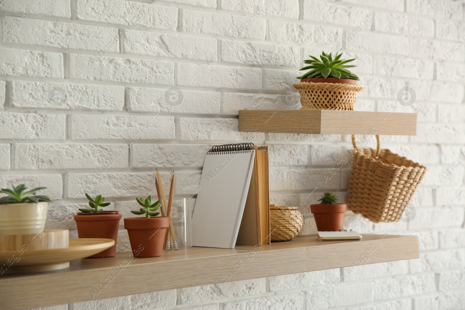 Shelves with decorative elements on white brick wall. Interior design Photo of Shelves with decorative elements on white brick wall. Interior design