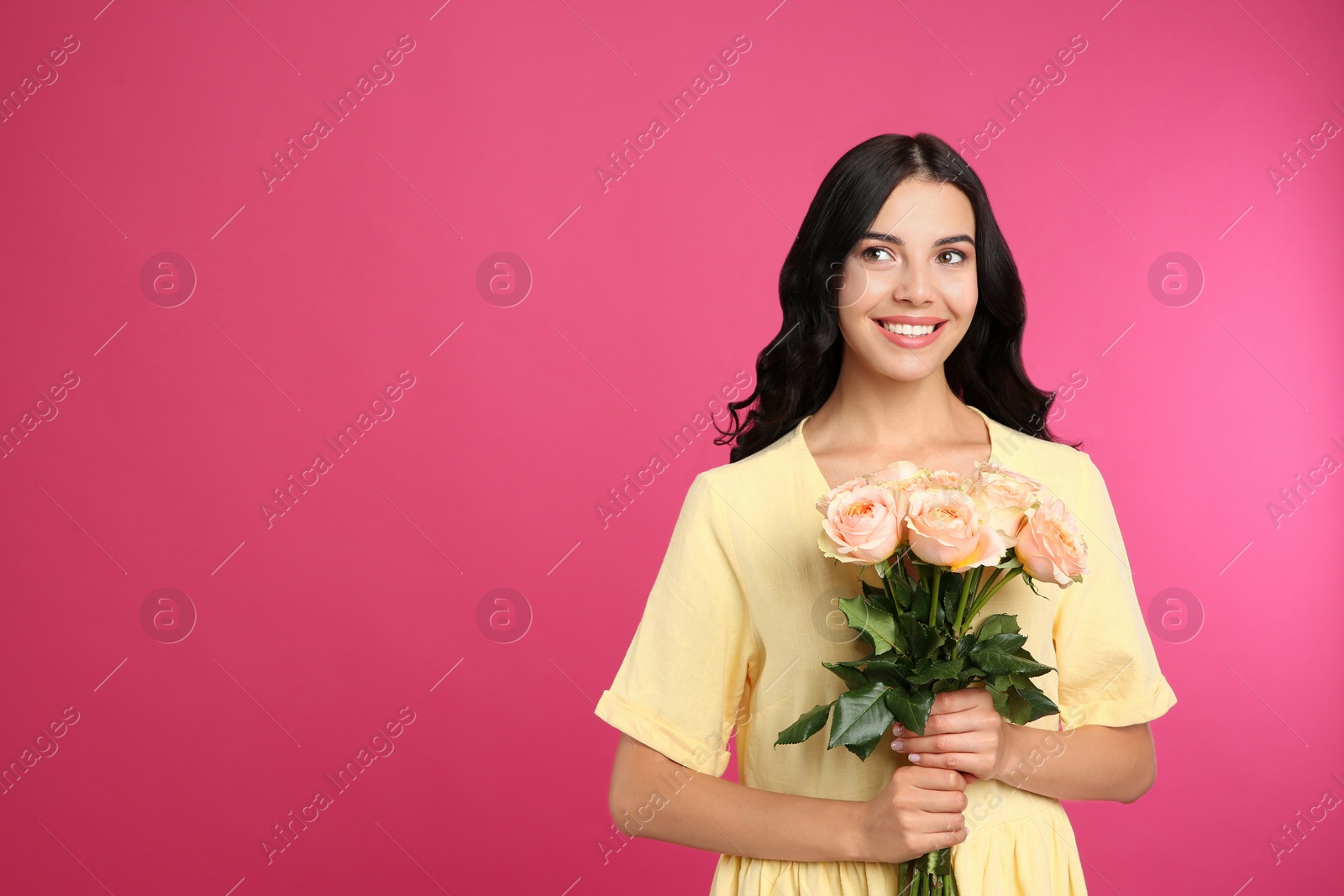 Photo of Portrait of smiling woman with beautiful bouquet on pink background. Space for text