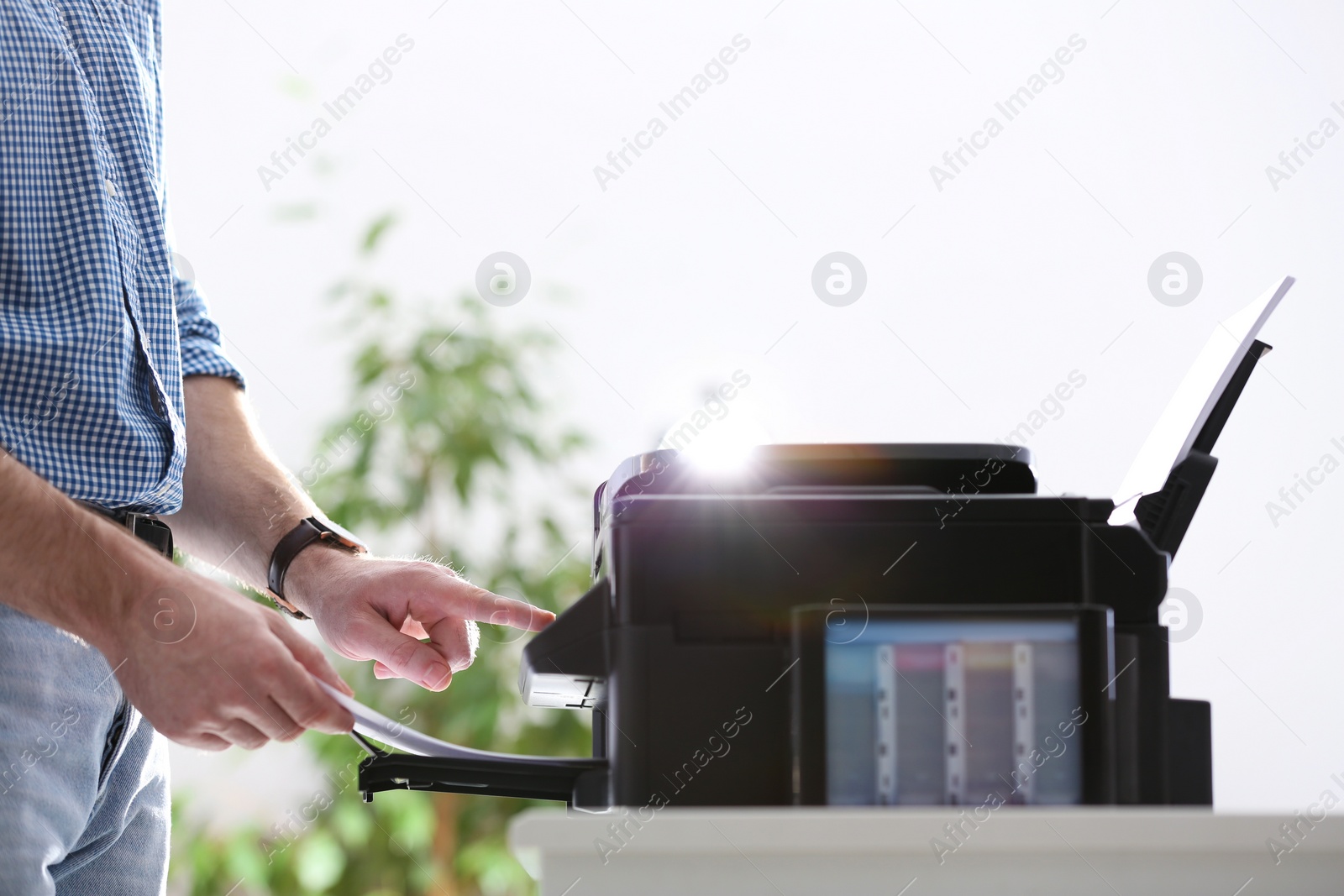 Employee using modern printer in office, closeup Photo of Employee using modern printer in office, closeup