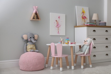 Children's room with modern furniture and pictures. Interior design Photo of Children's room with modern furniture and pictures. Interior design