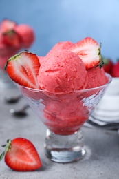 Delicious strawberry ice cream served on grey table Photo of Delicious strawberry ice cream served on grey table