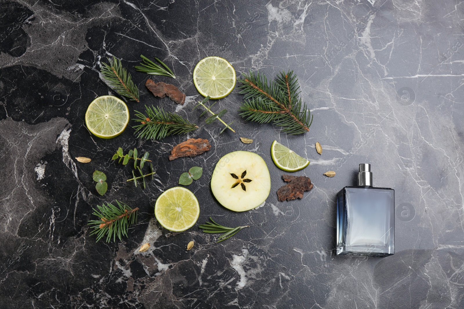 Flat lay composition with bottle of perfume on black marble background Photo of Flat lay composition with bottle of perfume on black marble background