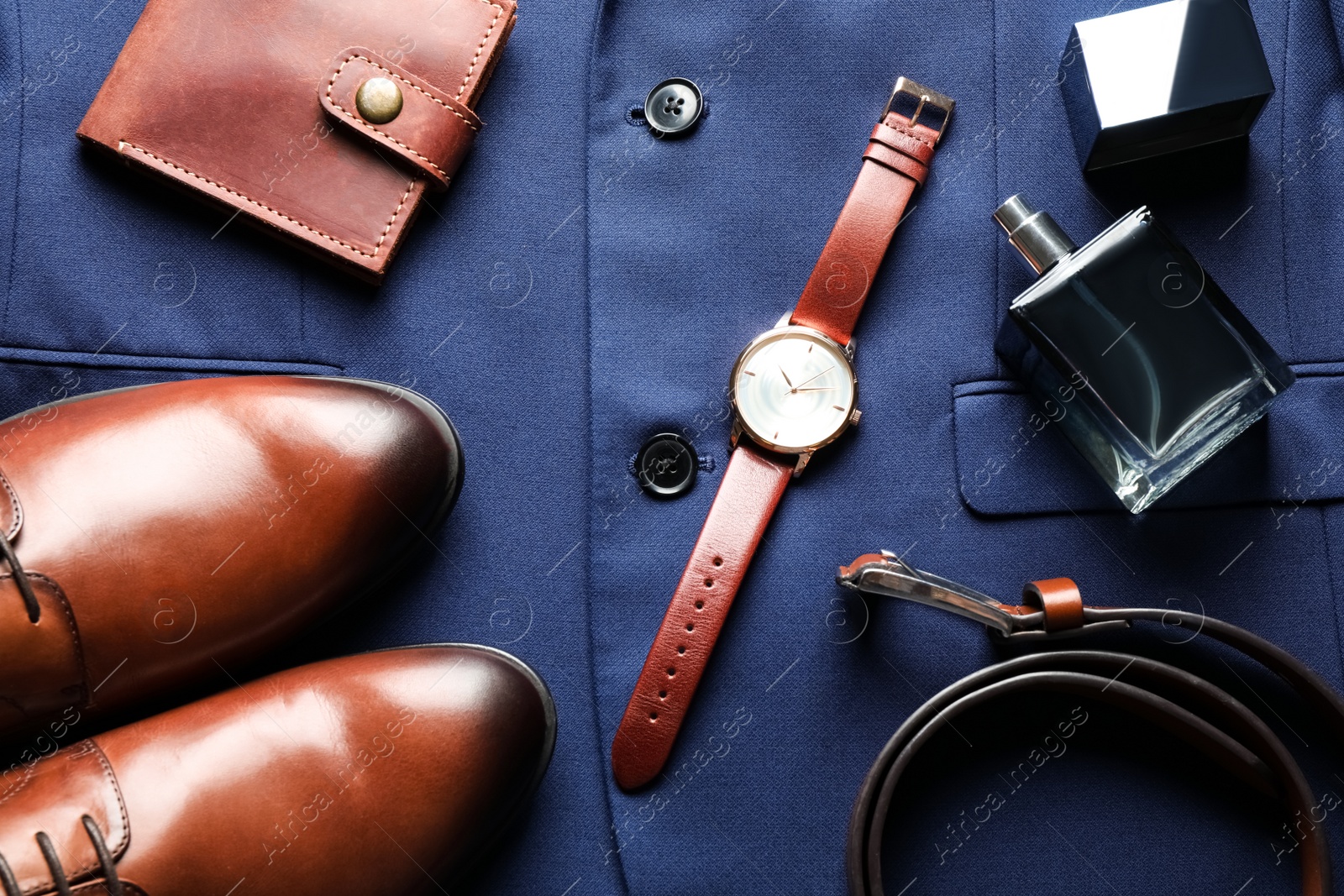 Flat lay composition with luxury wrist watch on blue shirt Photo of Flat lay composition with luxury wrist watch on blue shirt