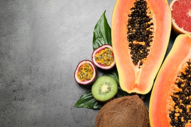 Fresh ripe papaya and other fruits on grey table, flat lay. Space for text Photo of Fresh ripe papaya and other fruits on grey table, flat lay. Space for text