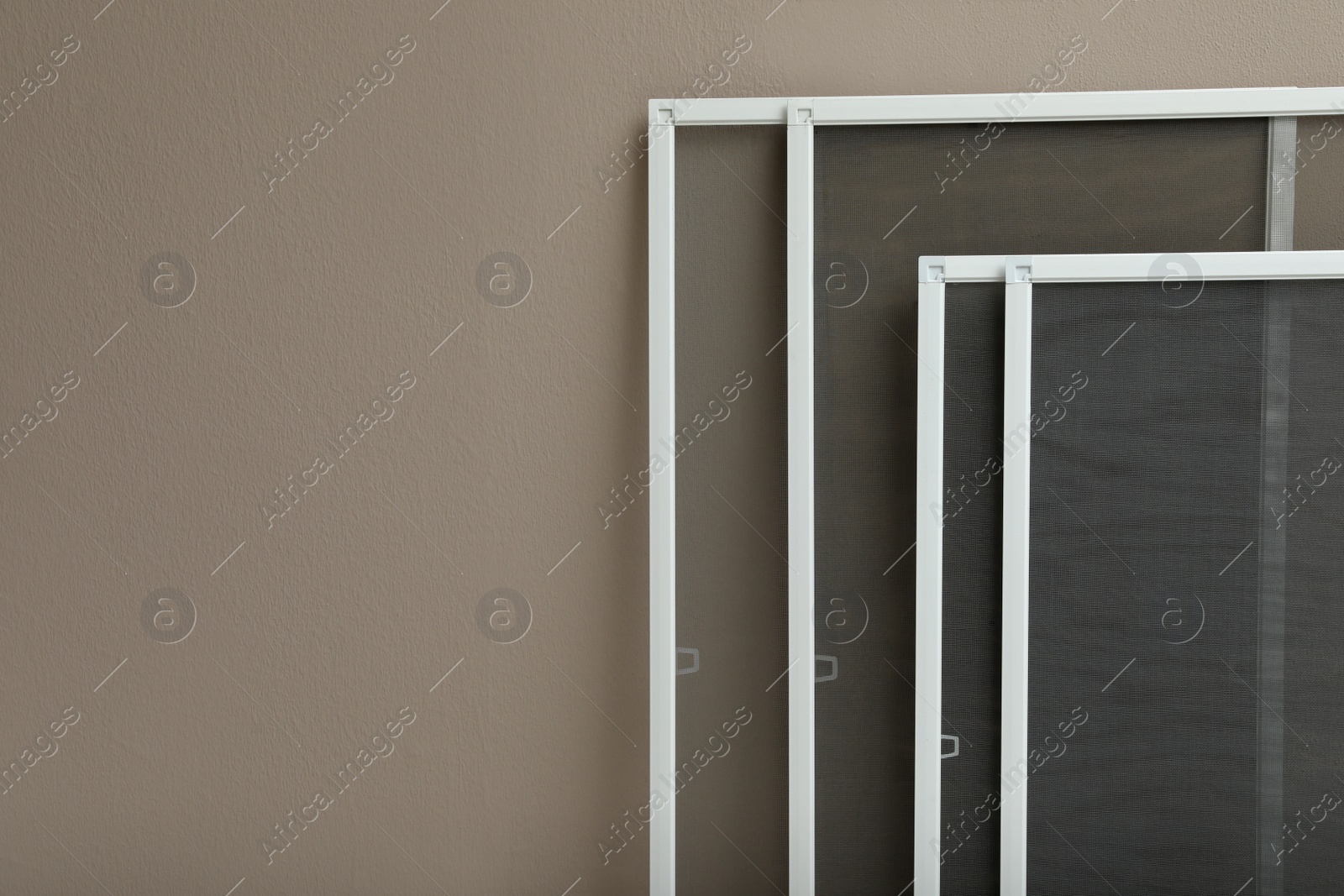 Set of window screens near beige wall. Space for text Photo of Set of window screens near beige wall. Space for text