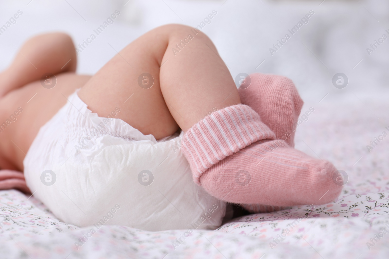 Little baby in diaper on bed, closeup Photo of Little baby in diaper on bed, closeup