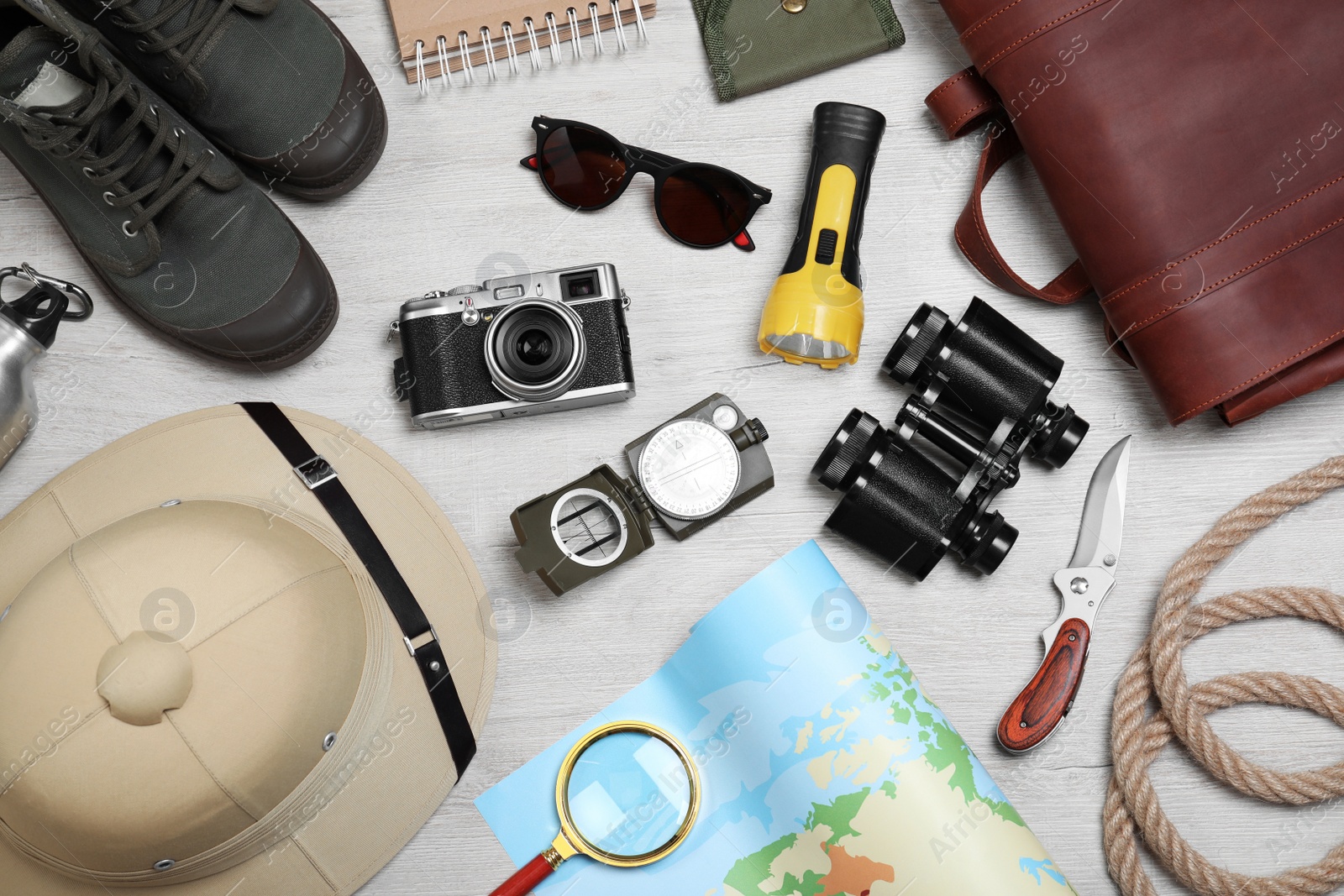 Flat lay composition with safari accessories on white wooden background Photo of Flat lay composition with safari accessories on white wooden background