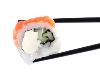 Chopsticks with tasty sushi roll on white background, closeup Photo of Chopsticks with tasty sushi roll on white background, closeup