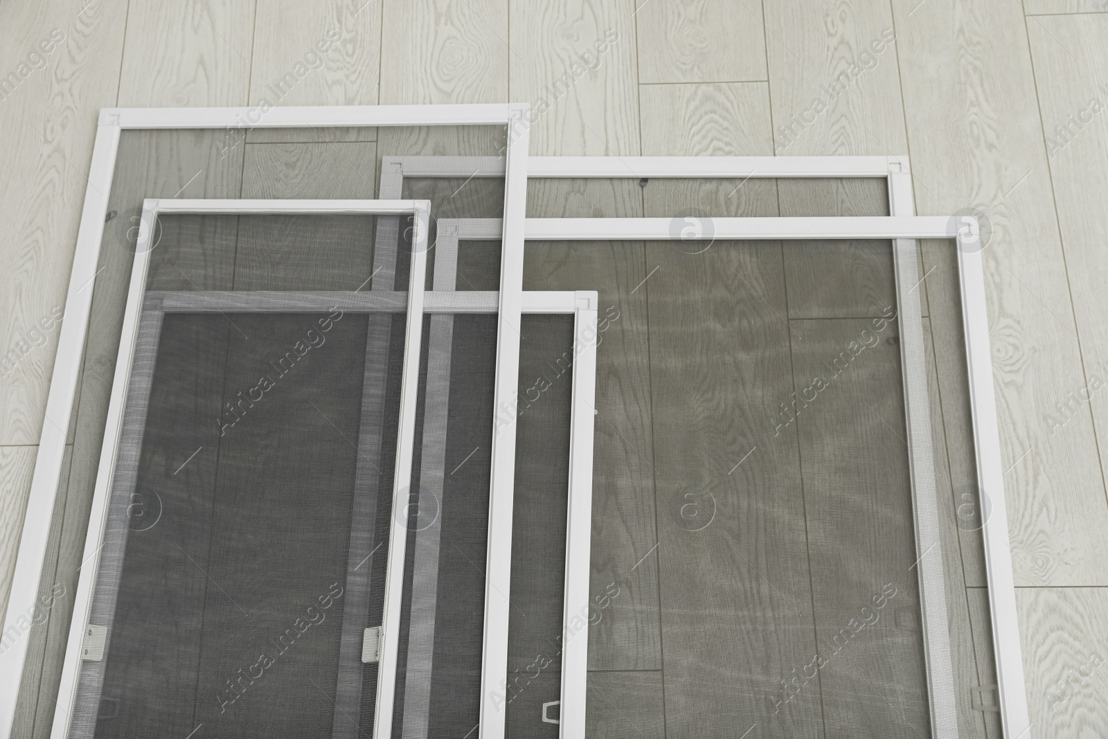 Set of window screens on wooden floor, above view Photo of Set of window screens on wooden floor, above view