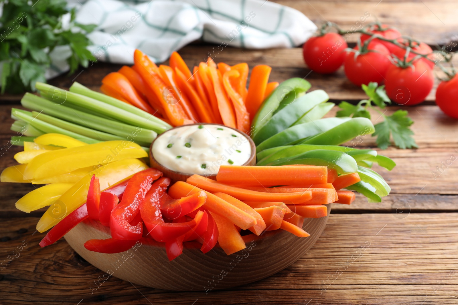 Different vegetables cut in sticks and dip sauce on wooden table, closeup Photo of Different vegetables cut in sticks and dip sauce on wooden table, closeup