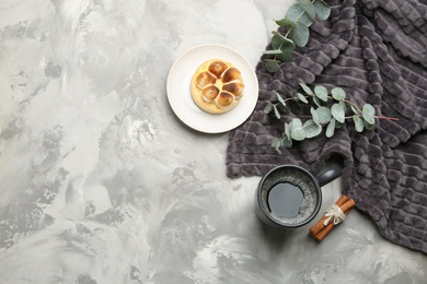 Flat lay composition with hot drink and warm plaid on grey table, space for text Photo of Flat lay composition with hot drink and warm plaid on grey table, space for text