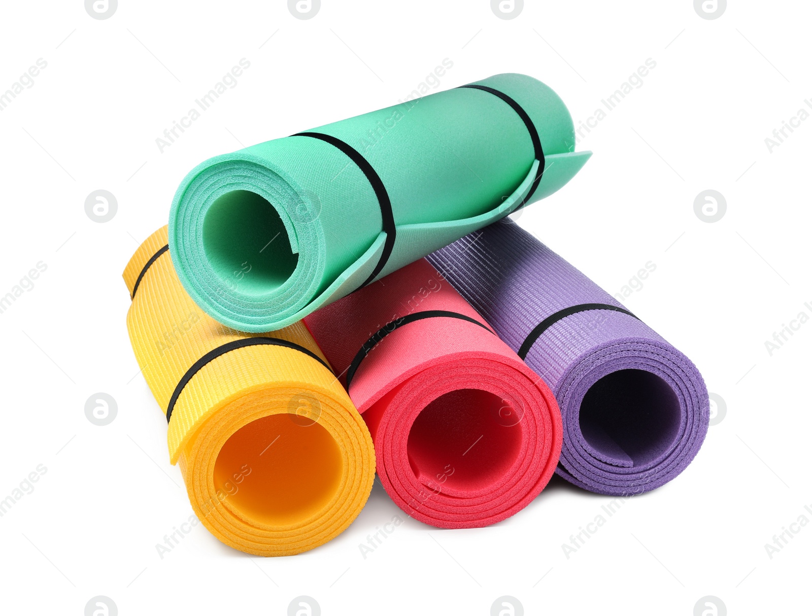Colorful rolled camping or exercise mats on white background Photo of Colorful rolled camping or exercise mats on white background