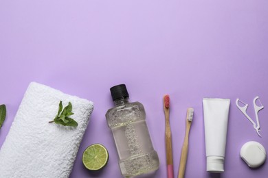 Flat lay composition with mouthwash and other oral hygiene products on violet background. Space for text Photo of Flat lay composition with mouthwash and other oral hygiene products on violet background. Space for text