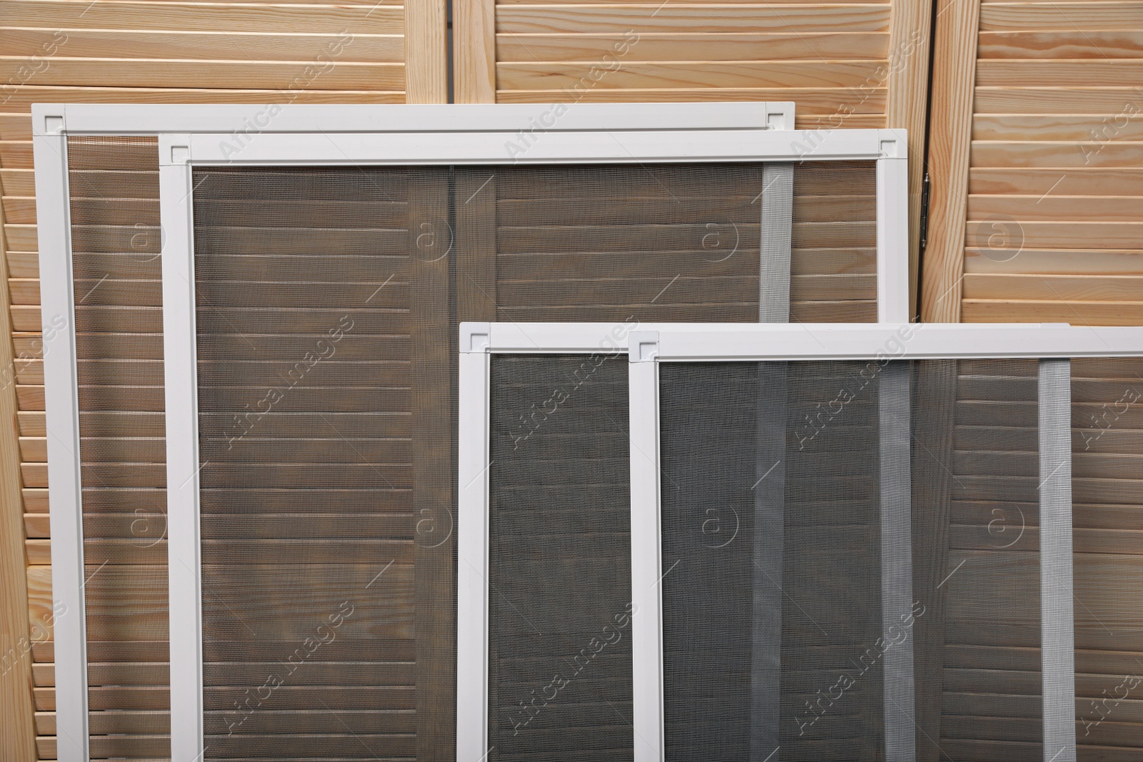 Set of window screens near wooden folding screen Photo of Set of window screens near wooden folding screen