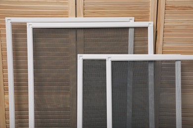 Set of window screens near wooden folding screen Photo of Set of window screens near wooden folding screen