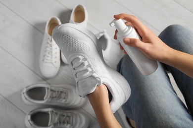 Woman cleaning stylish footwear indoors, closeup. Shoe care accessory Photo of Woman cleaning stylish footwear indoors, closeup. Shoe care accessory