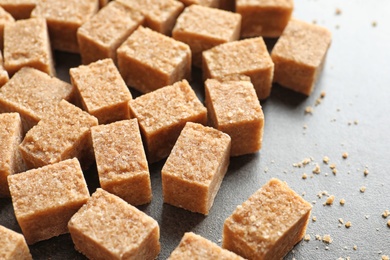 Cubes of brown sugar on table Photo of Cubes of brown sugar on table