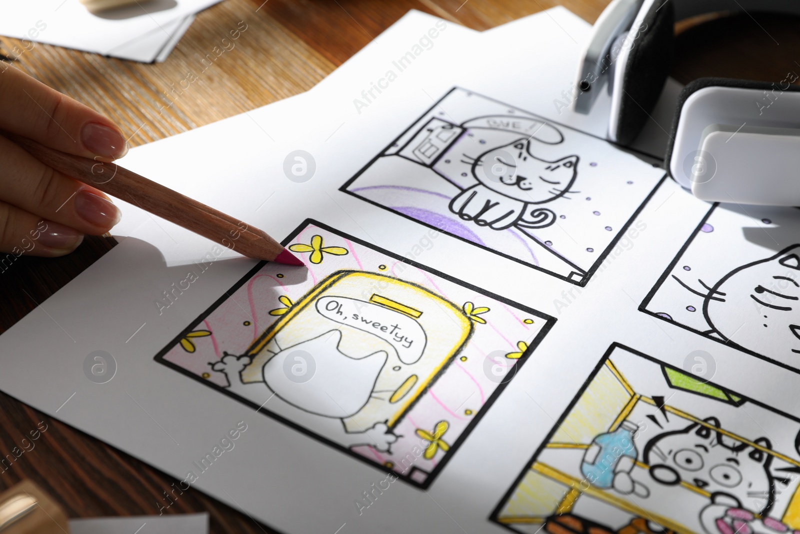 Woman drawing cartoon sketch at workplace, closeup. Pre-production process Photo of Woman drawing cartoon sketch at workplace, closeup. Pre-production process