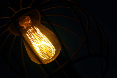 Stylish metallic pendant lamp with Edison light bulb indoors, closeup Image of Stylish metallic pendant lamp with Edison light bulb indoors, closeup