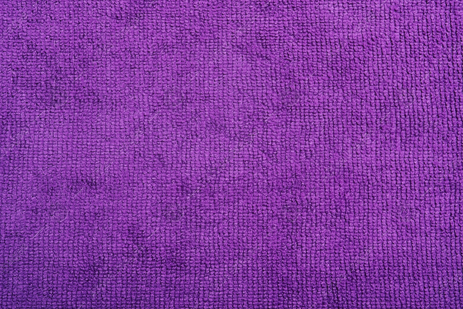 Purple microfiber cloth as background, top view Photo of Purple microfiber cloth as background, top view