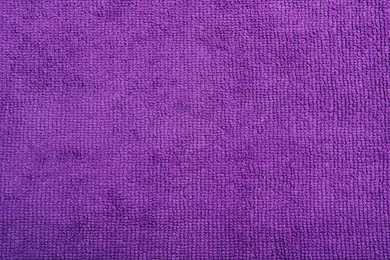Purple microfiber cloth as background, top view Photo of Purple microfiber cloth as background, top view