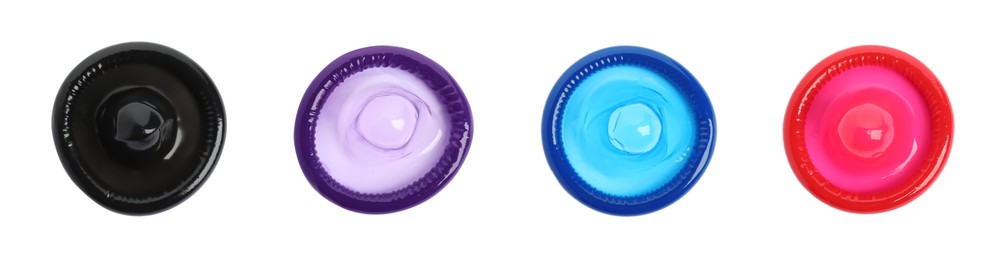 Set with different unpacked condoms on white background, top view. Banner design Image of Set with different unpacked condoms on white background, top view. Banner design
