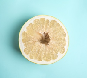 Fresh cut pomelo fruit on light blue background, top view Photo of Fresh cut pomelo fruit on light blue background, top view