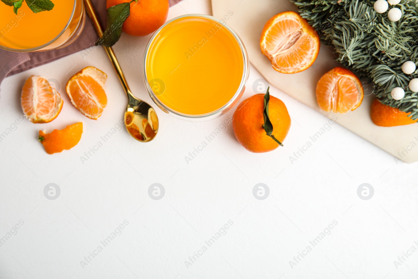 Delicious tangerine jelly and fresh fruits on white table, flat lay. Space for text Photo of Delicious tangerine jelly and fresh fruits on white table, flat lay. Space for text