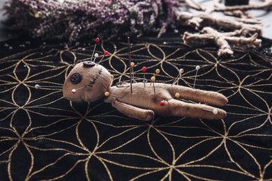 Voodoo doll pierced with pins on table. Curse ceremony Photo of Voodoo doll pierced with pins on table. Curse ceremony