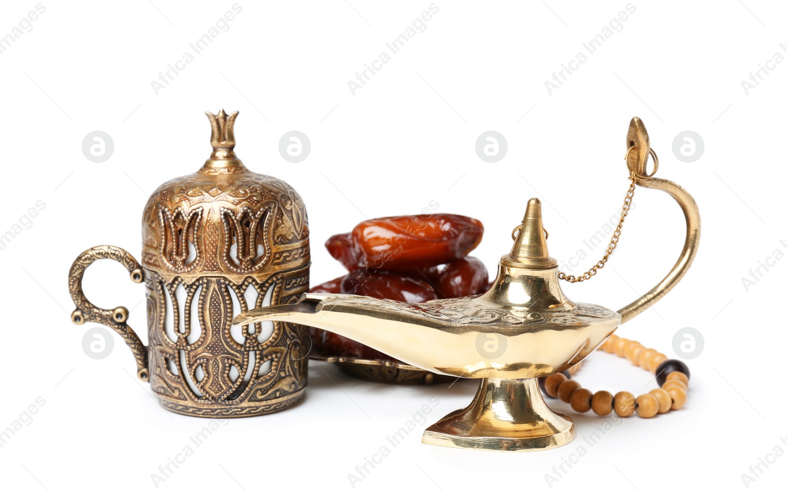 Aladdin magic lamp, dates and beads on white background Photo of Aladdin magic lamp, dates and beads on white background