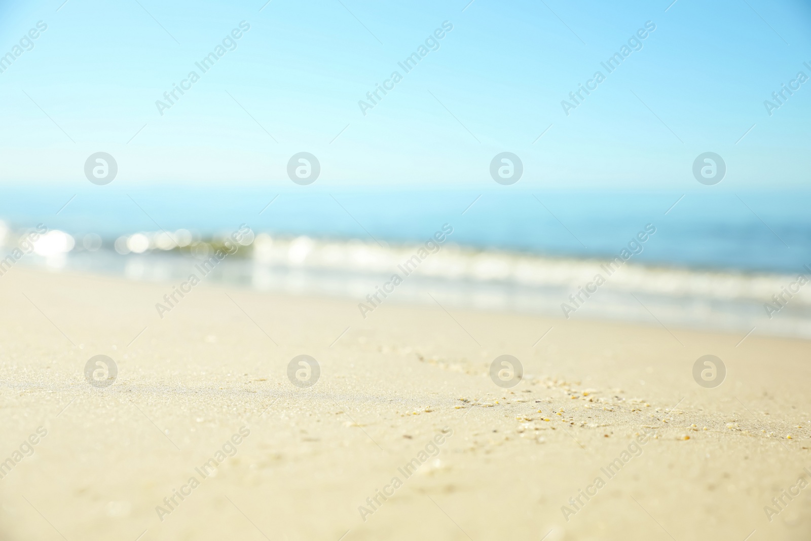 Beautiful sandy beach and sea under blue sky, closeup Photo of Beautiful sandy beach and sea under blue sky, closeup