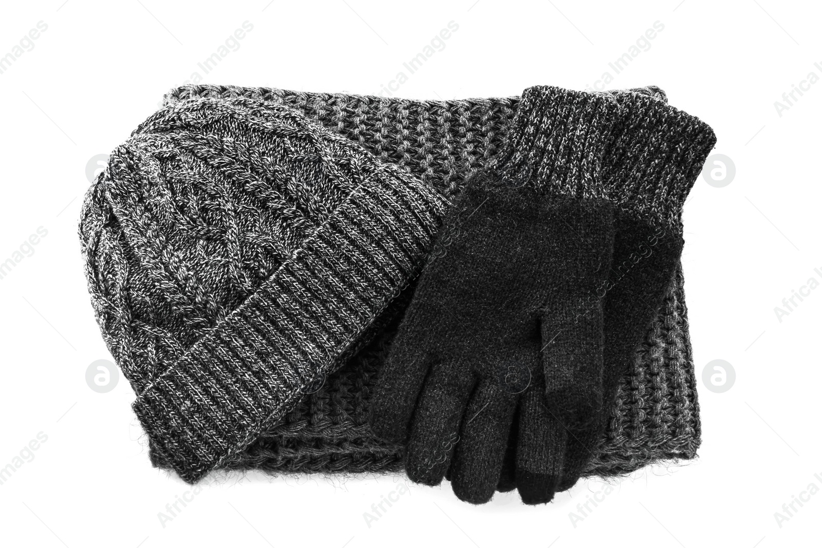 Photo of Black woolen gloves, scarf and hat on white background, top view. Winter clothes