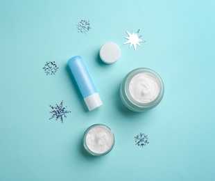 Flat lay composition with different cosmetic products on turquoise background. Winter care Photo of Flat lay composition with different cosmetic products on turquoise background. Winter care