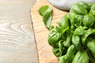 Fresh basil on wooden table, closeup. Space for text Photo of Fresh basil on wooden table, closeup. Space for text
