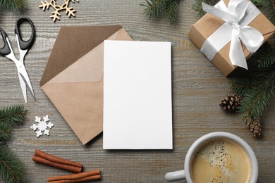 Flat lay composition with Christmas decor and blank card on wooden background. Space for text Photo of Flat lay composition with Christmas decor and blank card on wooden background. Space for text