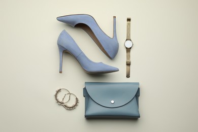 Stylish woman's bag, shoes and accessories on light background, flat lay Photo of Stylish woman's bag, shoes and accessories on light background, flat lay