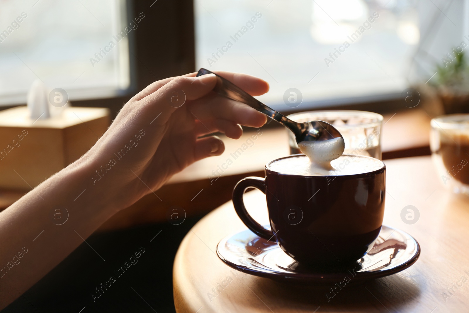 Woman with aromatic coffee at table in cafe, closeup Photo of Woman with aromatic coffee at table in cafe, closeup