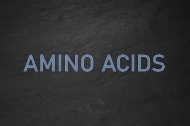 Illustration of Text Amino Acids on black slate surface