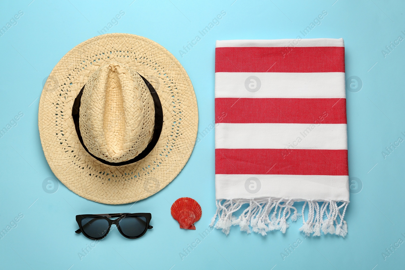 Flat lay composition with different beach objects on light blue background Photo of Flat lay composition with different beach objects on light blue background