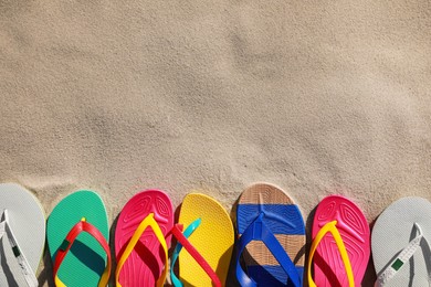 Stylish flip flops on beach, flat lay. Space for text Photo of Stylish flip flops on beach, flat lay. Space for text