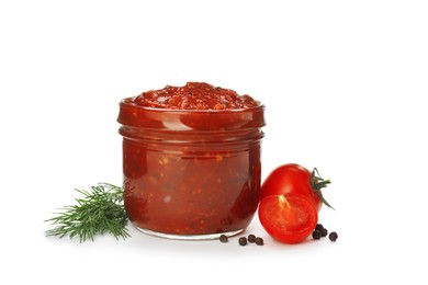 Delicious adjika sauce in glass jar and ingredients isolated on white Photo of Delicious adjika sauce in glass jar and ingredients isolated on white