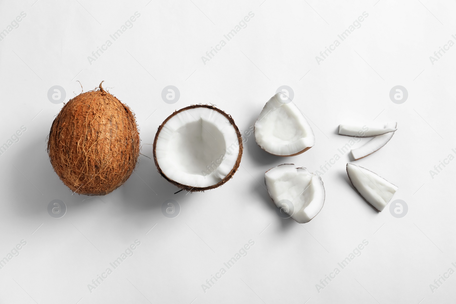 Pieces of coconut on white background, flat lay Photo of Pieces of coconut on white background, flat lay