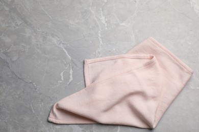Pink kitchen towel on grey table, top view. Space for text Photo of Pink kitchen towel on grey table, top view. Space for text