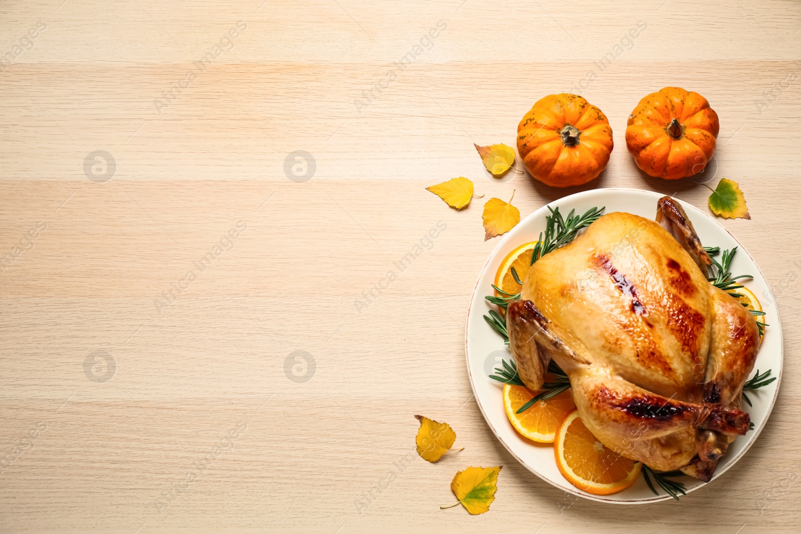 Traditional cooked turkey and autumn decor on wooden table, flat lay with space for text. Thanksgiving day celebration Photo of Traditional cooked turkey and autumn decor on wooden table, flat lay with space for text. Thanksgiving day celebration
