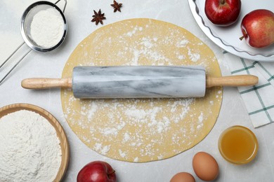 Flat lay composition with raw dough and ingredients on light grey table. Baking apple pie Photo of Flat lay composition with raw dough and ingredients on light grey table. Baking apple pie