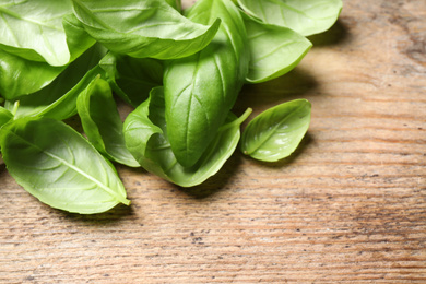 Fresh basil leaves on wooden table, closeup Photo of Fresh basil leaves on wooden table, closeup